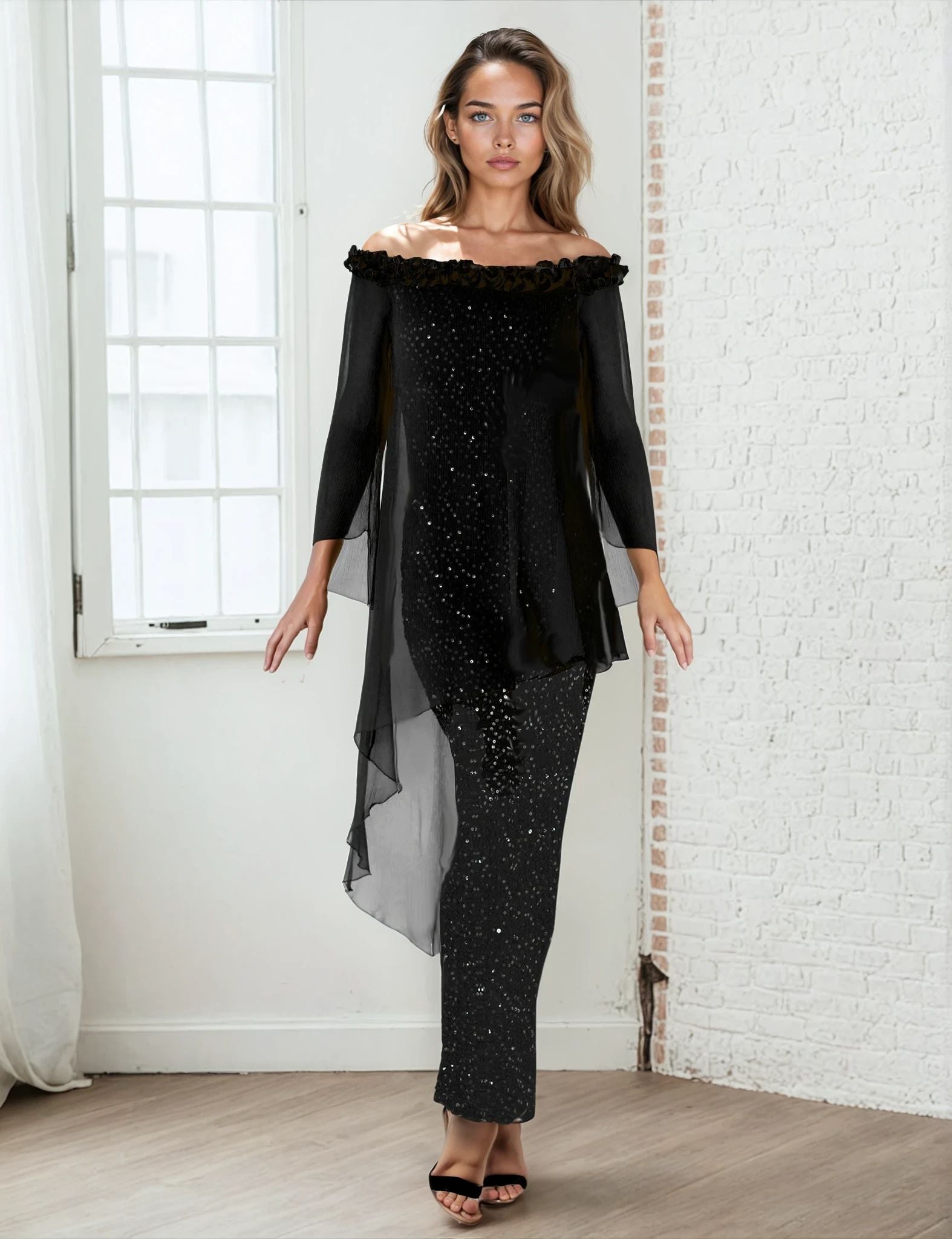 Woman wearing a black off-shoulder top and black sequin skirt in a room with white walls.