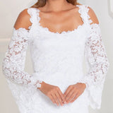 White lace blouse with long sleeves on a plain background