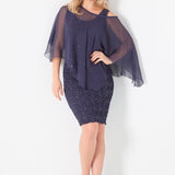 Woman wearing a short silk sequin tank dress with a silk poncho on a white background