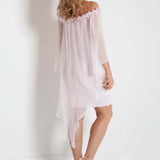 Woman wearing a pink off-shoulder dress against a white background