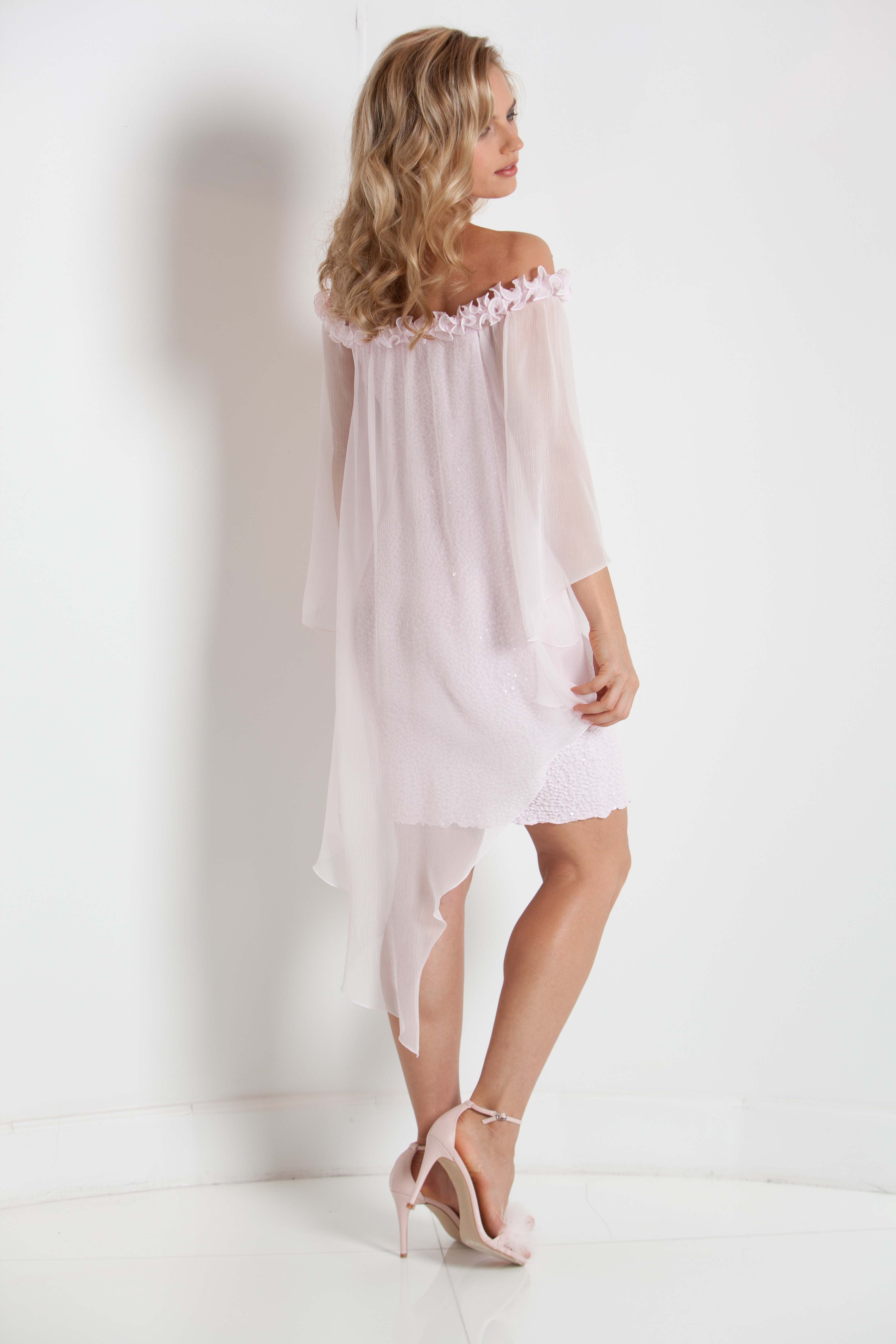 Woman wearing a pink off-shoulder dress against a white background