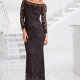 Woman wearing a black lace dress in a white interior setting