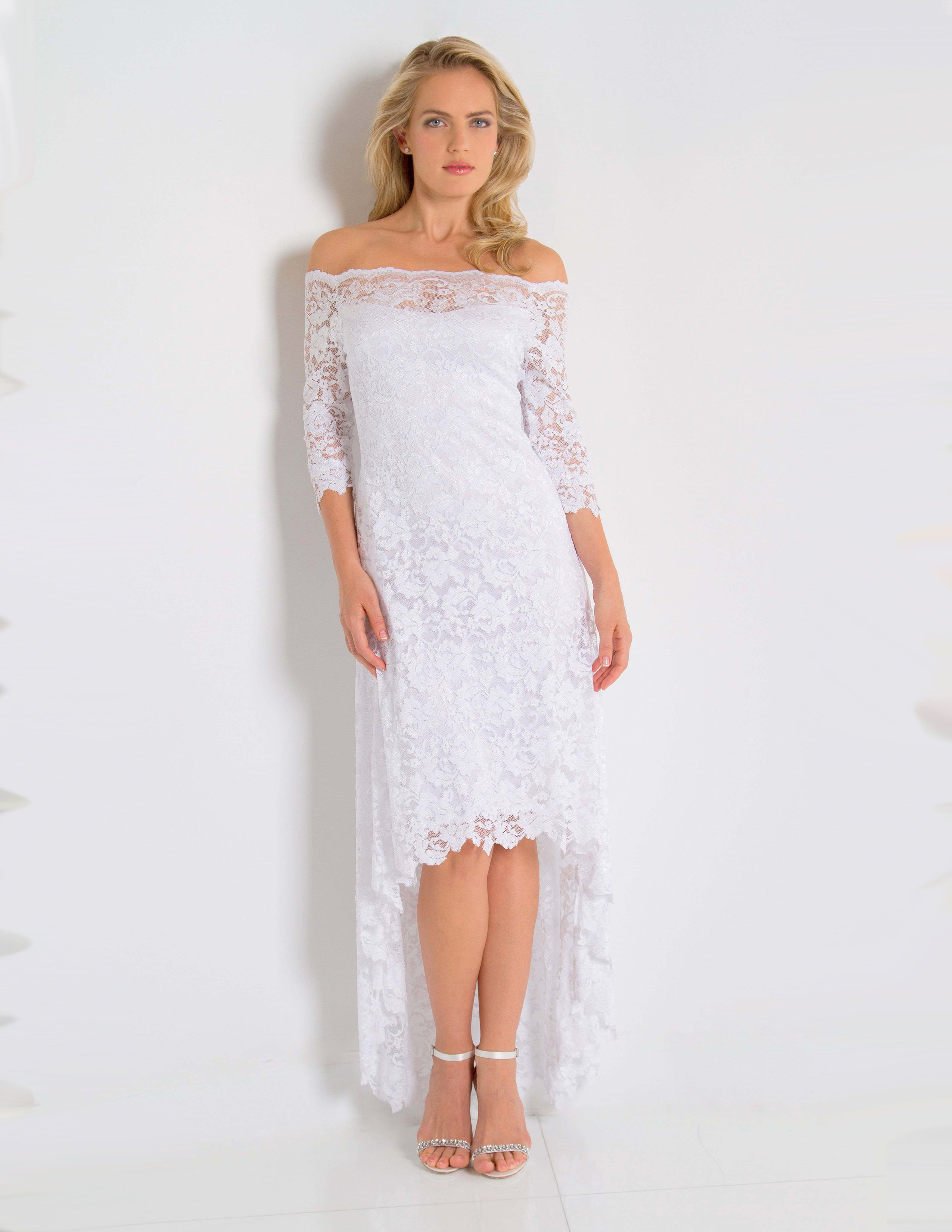 Woman wearing a white lace dress against a plain background