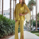 Woman in a green outfit walking on a sidewalk with palm trees in the background