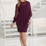 Woman wearing a burgundy sequin  dress with a chiffon tunic in a white room.