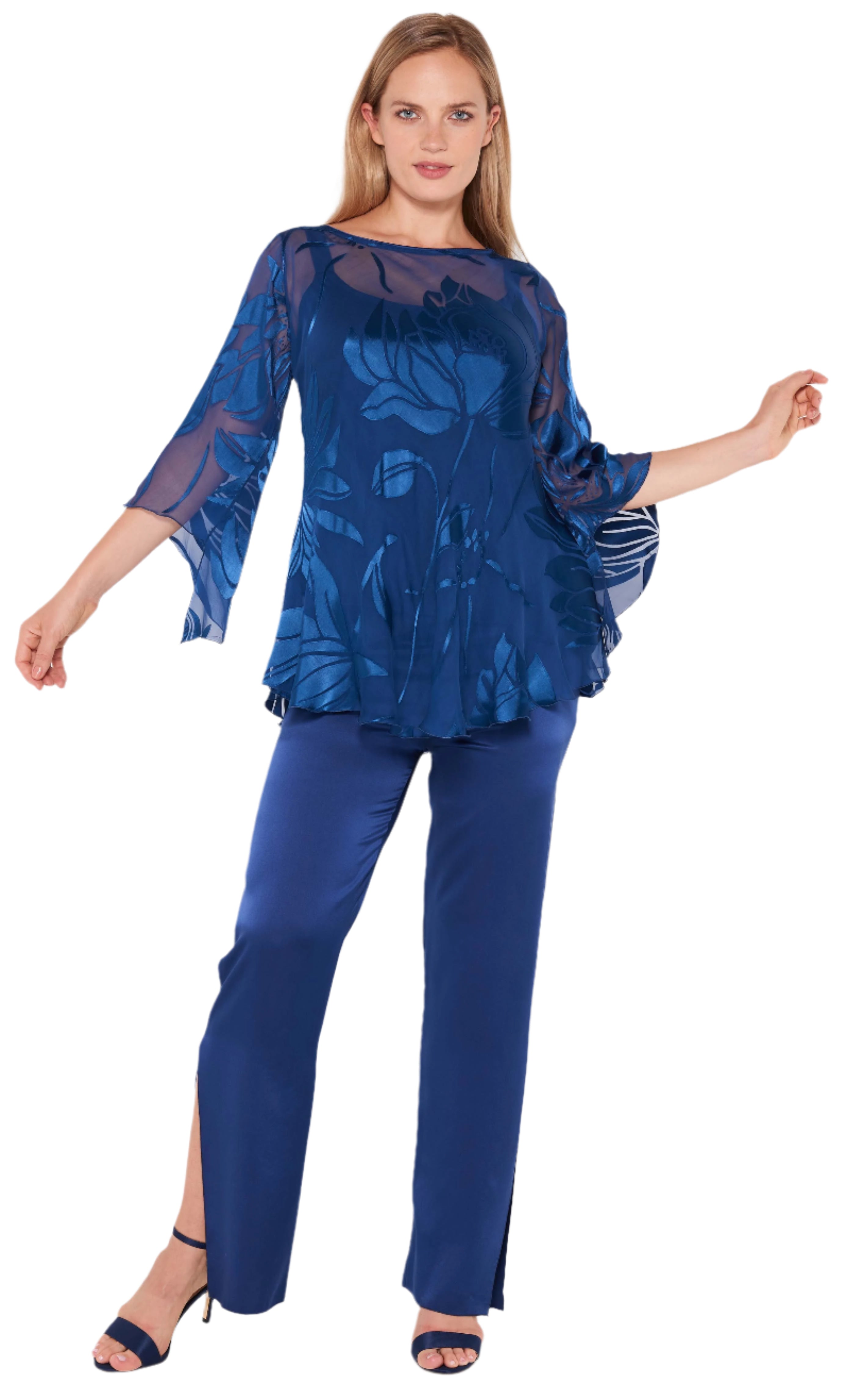 Woman wearing a blue floral top and pants on a white background