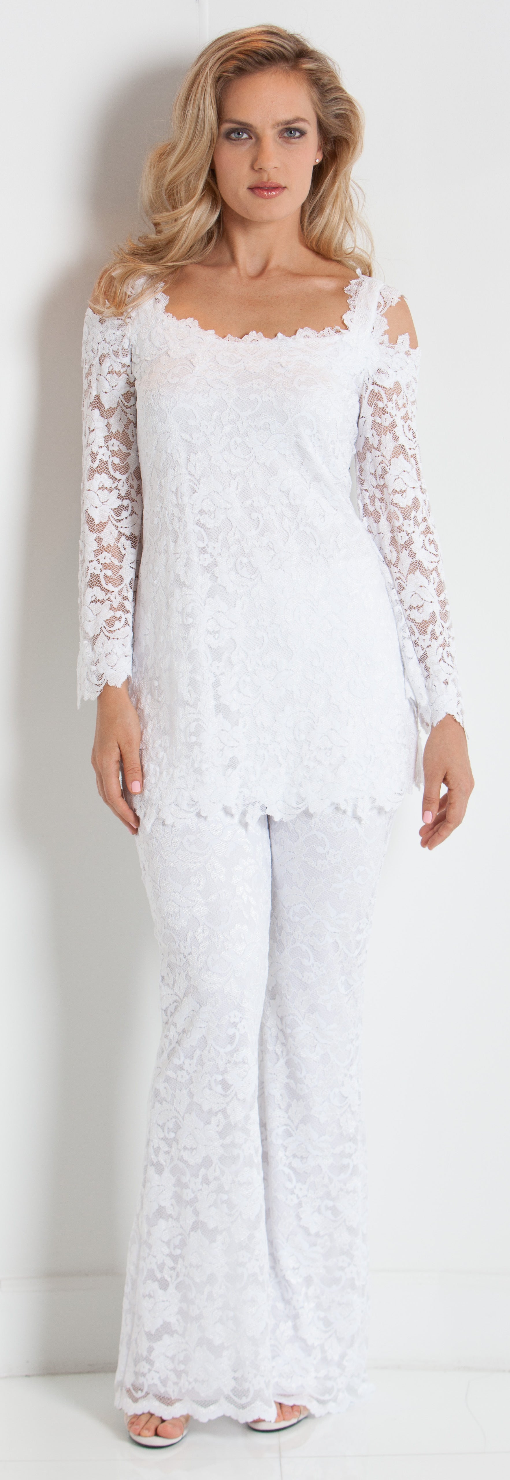 Woman wearing a white lace outfit against a white background