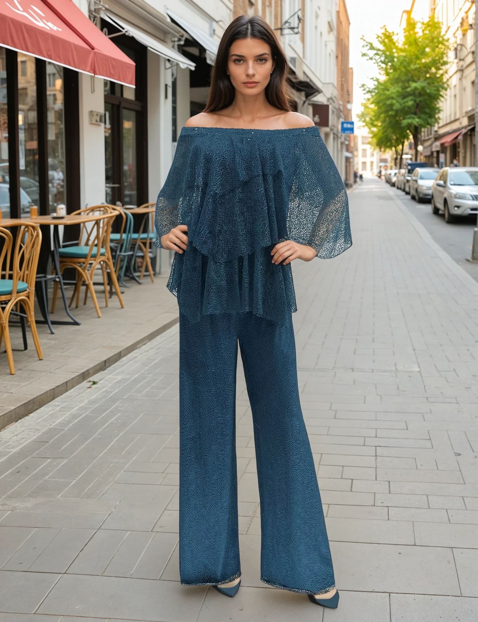 Woman in a blue outfit standing on a city street