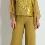 Woman wearing a green outfit with a white background