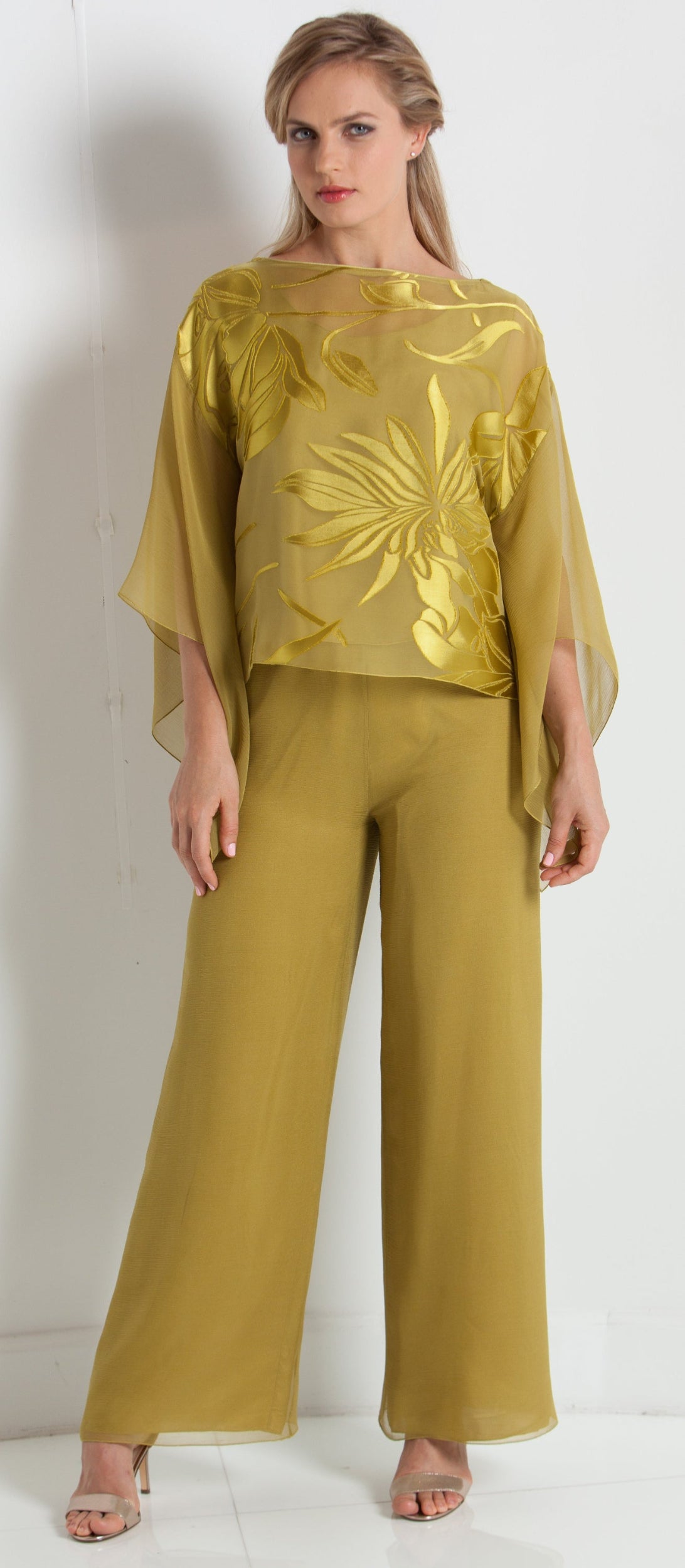 Woman wearing a green outfit with a white background