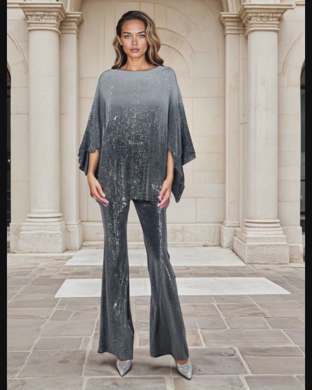Women in two-piece gray sequin outfit with Collums in background 