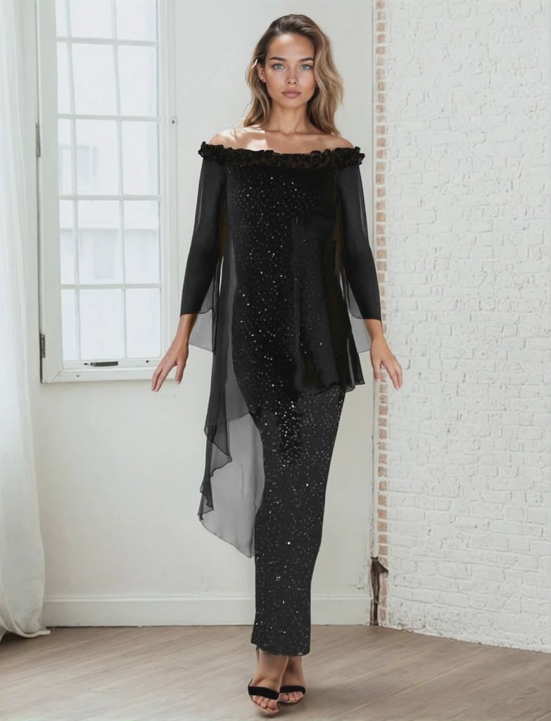 Woman wearing a black off-shoulder top and black sequin skirt in a room with white walls.