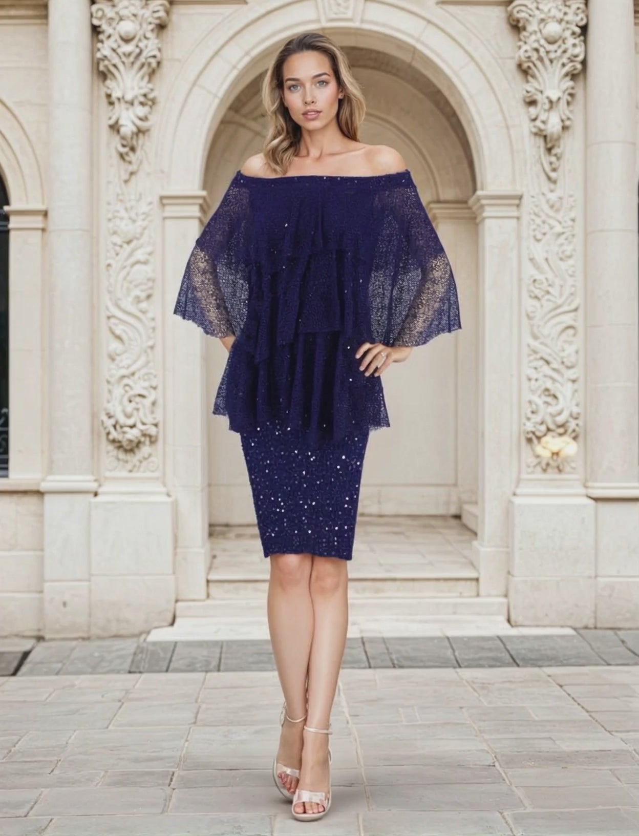Woman wearing a short sequin dress with fishnet layered off the shoulder top on a classical background