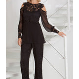 Woman Standing on stairway in a Lace Cold Shoulder Top & Lace Straight Leg Pant 